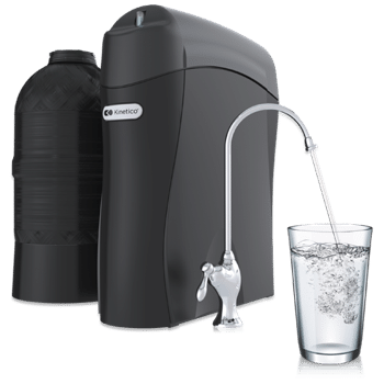 A Kinetico water filtration system dispensing clean water into a glass
